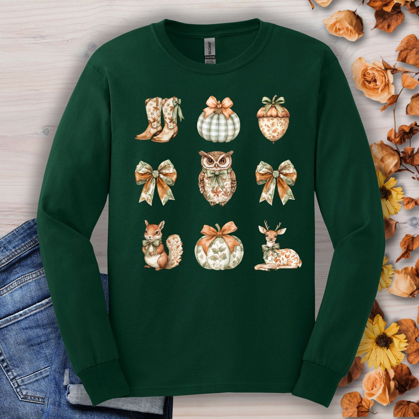 Forest Green long sleeve tee with fall-themed watercolor designs: owl, squirrel, deer, pumpkins, bows, boots, acorn.