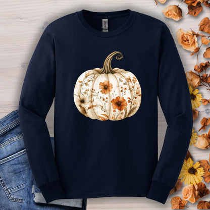 Navy long sleeve tee with a white boho floral pumpkin design, surrounded by autumn leaves and flowers.