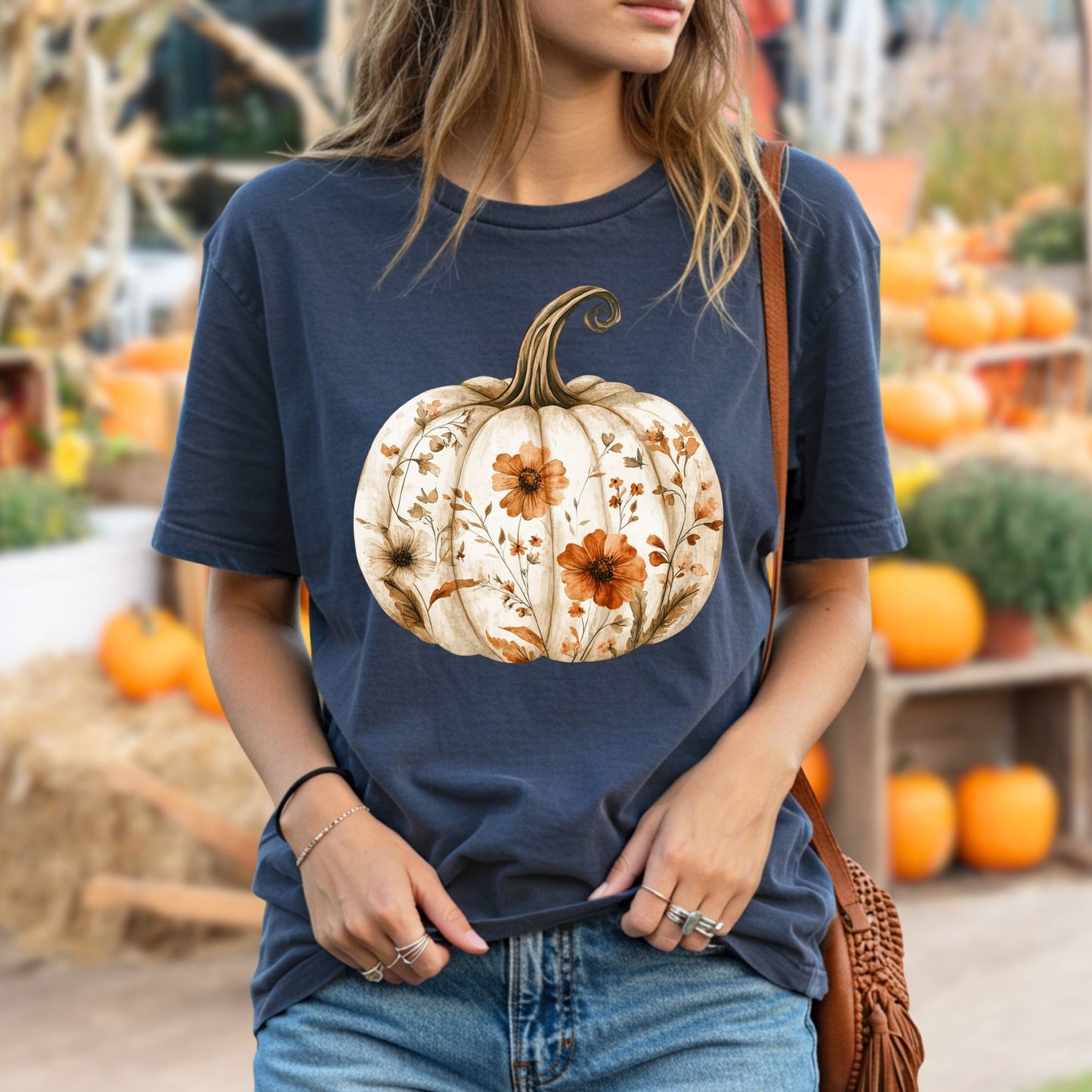 Garment-dyed navy t-shirt with a white pumpkin blooming with delicate orange wildflowers.