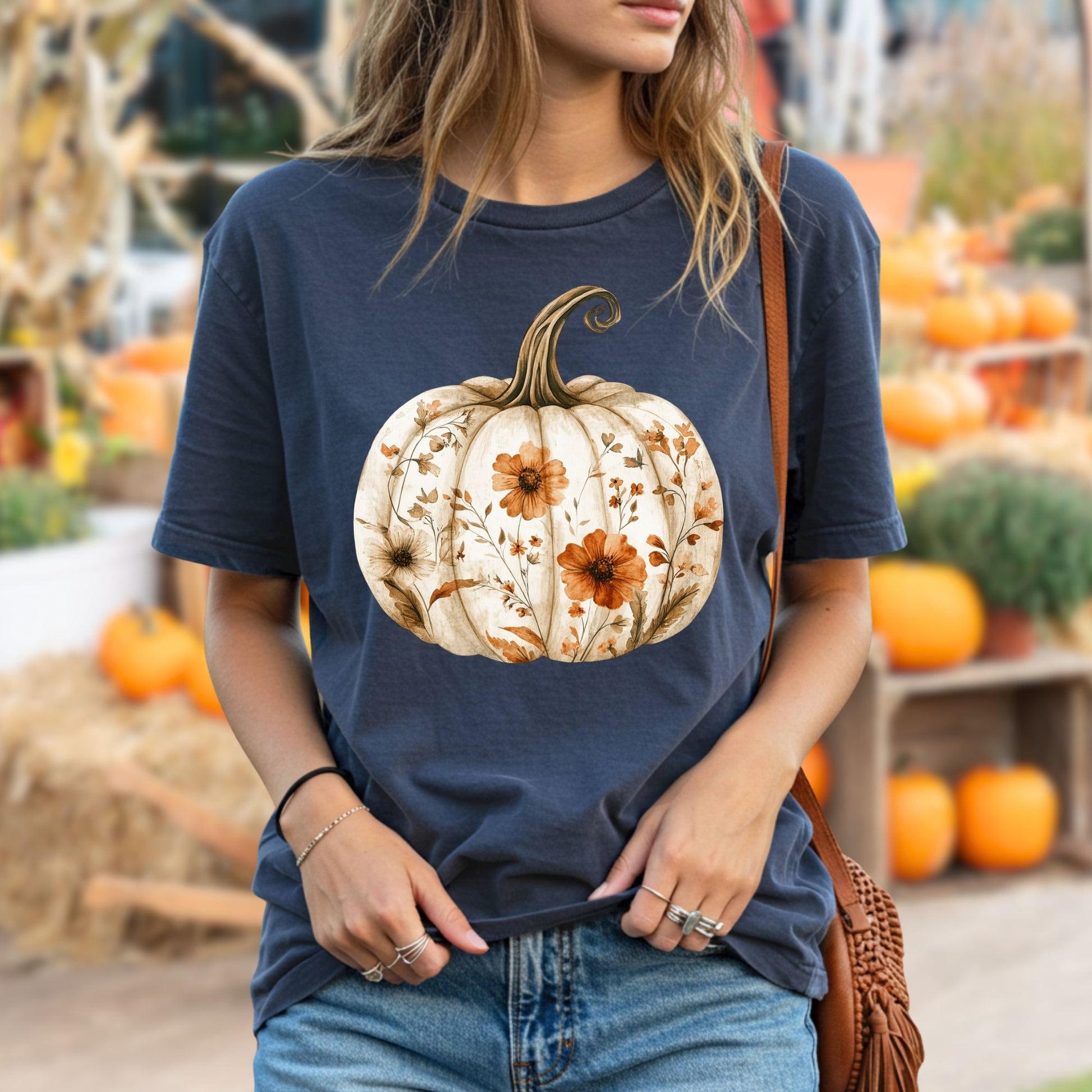 Garment-dyed navy t-shirt with a white pumpkin blooming with delicate orange wildflowers.