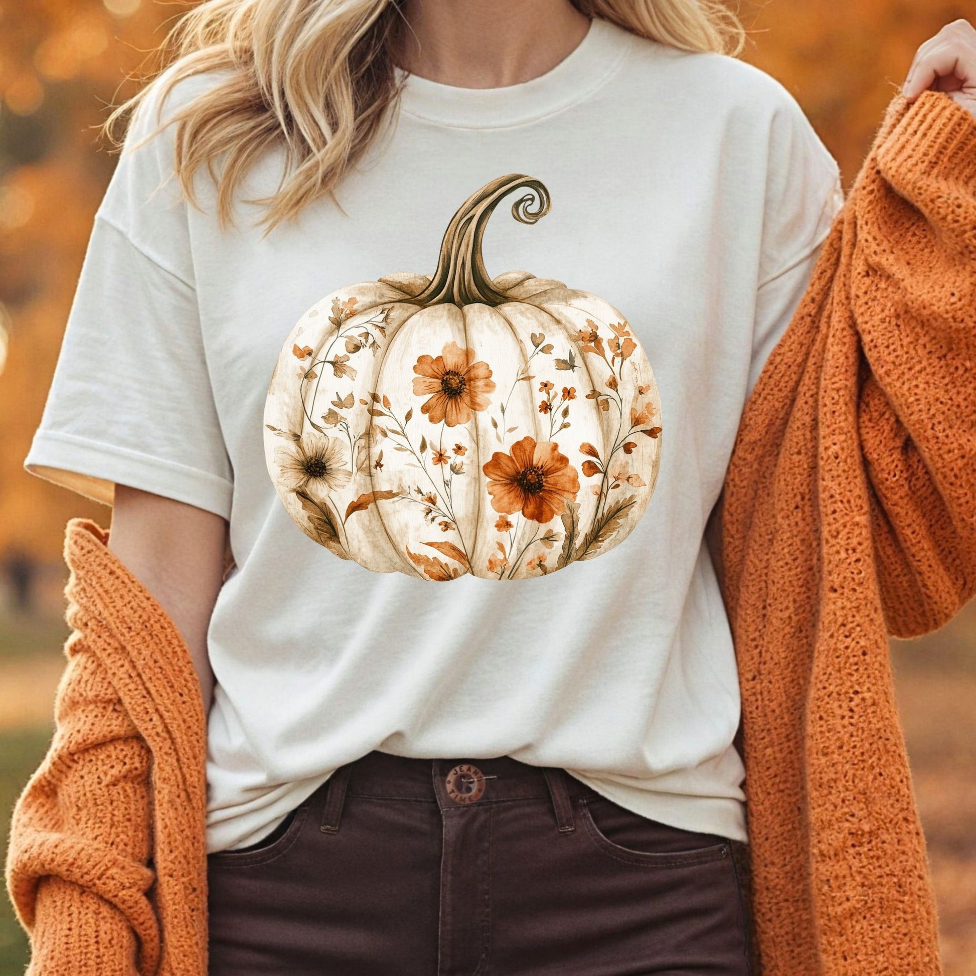 Relaxed-fit, garment-dyed white t-shirt with a hand-painted floral pumpkin design and an orange cardigan.