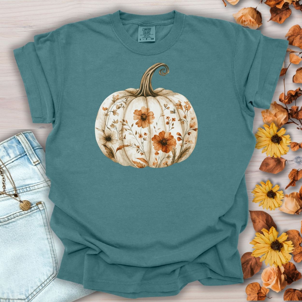 Blue Spruce Boho Floral Pumpkin T-Shirt, relaxed-fit, 100% cotton, with a white pumpkin and wildflowers.