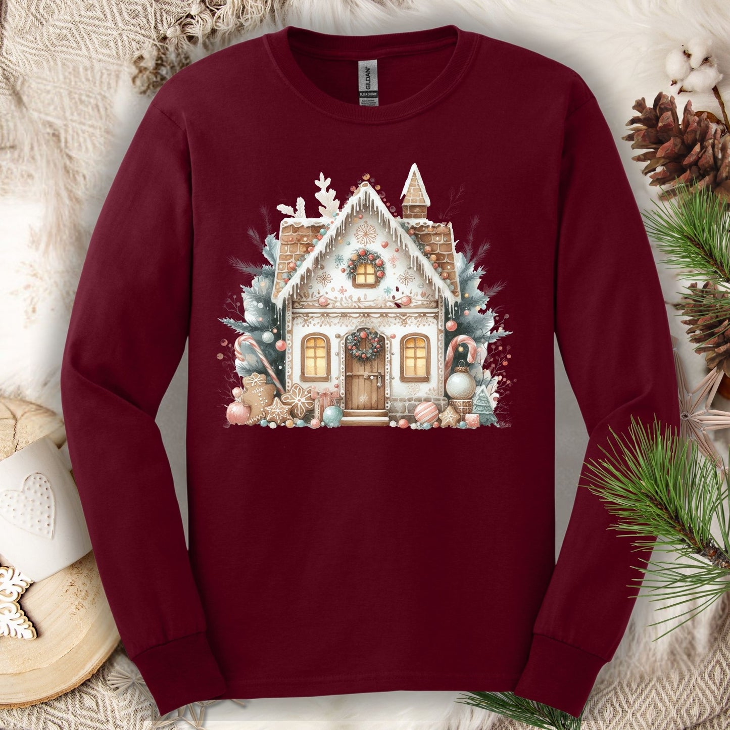 Maroon Gildan Softstyle long sleeve tee with a watercolor boho gingerbread house design.