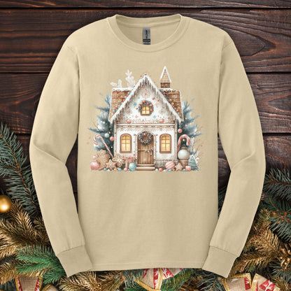 Sand Gildan long sleeve tee with a watercolor boho gingerbread house in muted tan, blush, and blue.