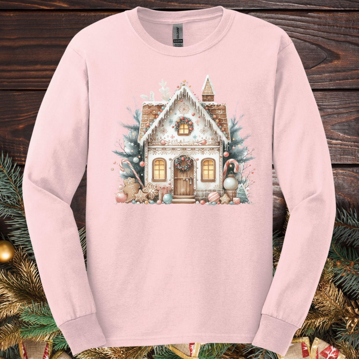 Light pink long sleeve tee with a watercolor boho gingerbread house in tan, blush, and powder blue.