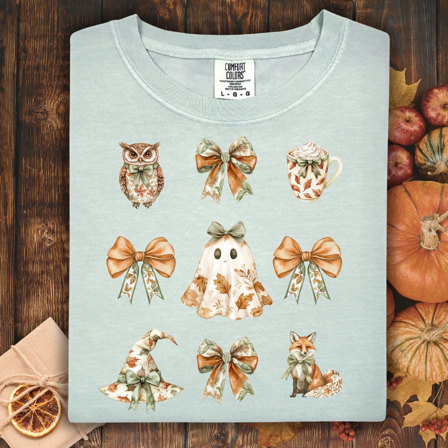 Bay-colored Comfort Colors t-shirt with boho Halloween favorites: owl, bows, latte, ghost, witch hat, and fox.