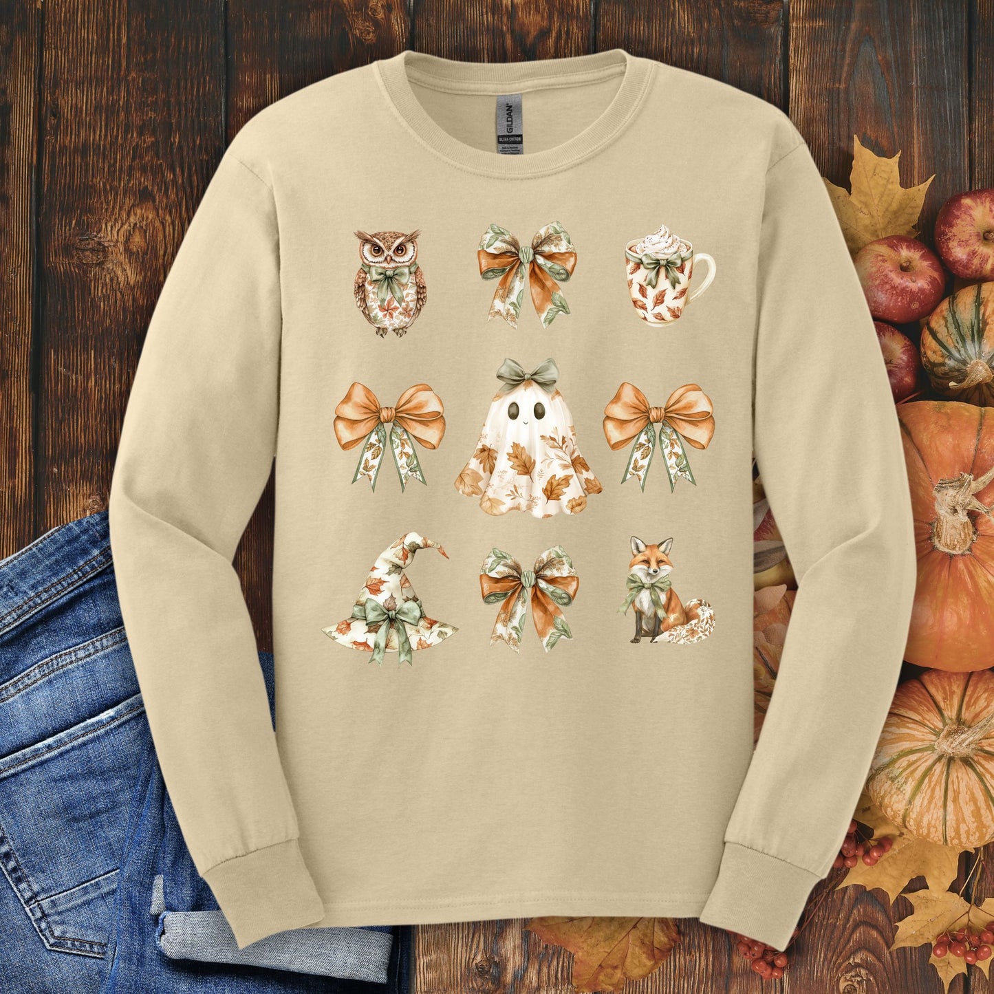 Sand long-sleeve tee with boho Halloween ghost, witch hat, fox, owl, bows, and mug designs.