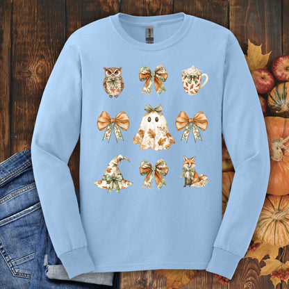 Light blue long sleeve cotton tee with a boho Halloween design: ghost, witch hat, fox, owl, bows, and mug.