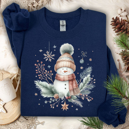 Navy S crewneck sweatshirt with boho watercolor snowman, flannel scarf, hat, and evergreen sprigs.