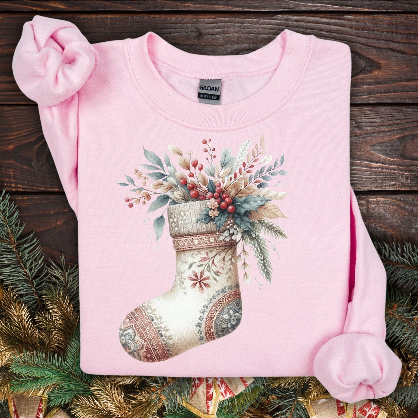 Light pink Gildan sweatshirt with a watercolor boho stocking filled with evergreen and berries.