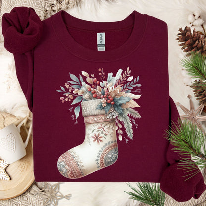 Maroon Gildan sweatshirt with a watercolor boho stocking overflowing with muted seasonal greenery and berries.