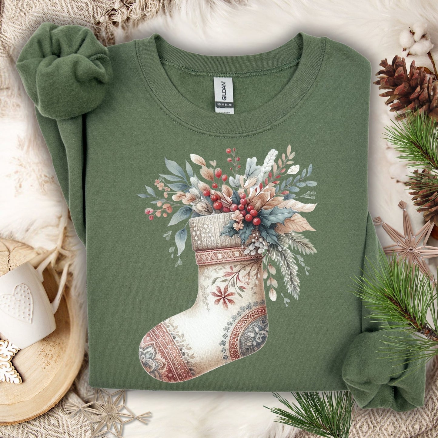Military Green S sweatshirt with a watercolor boho stocking design filled with evergreen, berries, and foliage.