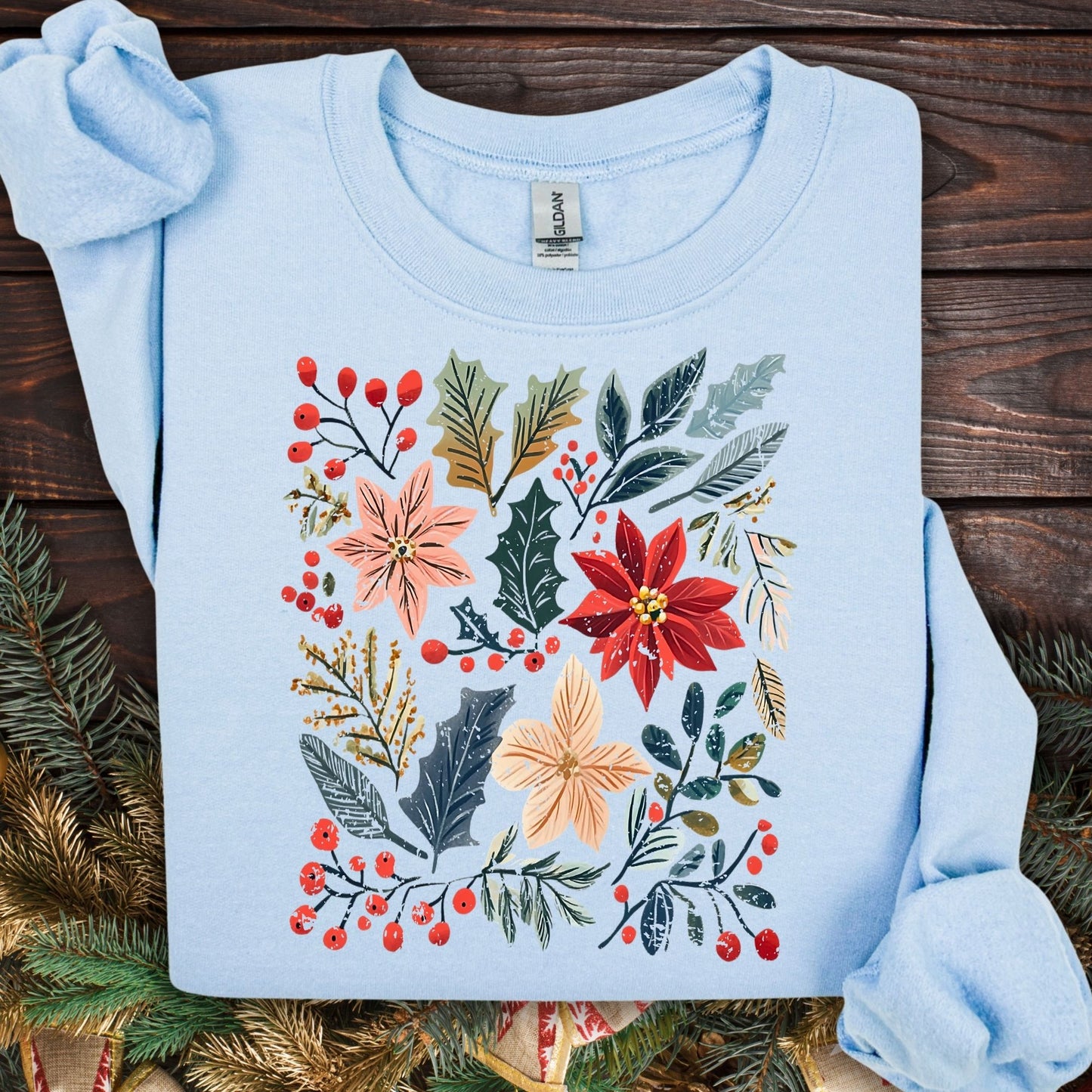 Light blue Gildan sweatshirt with vibrant boho watercolor poinsettia and holly floral design.
