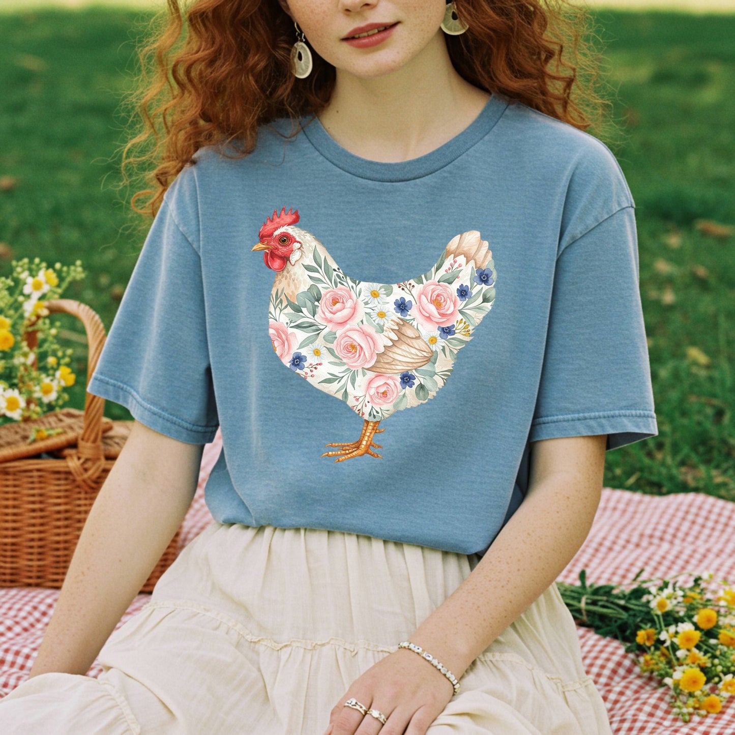 Garment-dyed blue t-shirt with a botanical chicken design featuring roses and daisies.