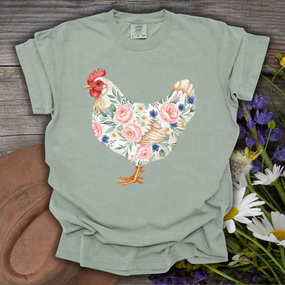 Bay S t-shirt with a botanical chicken design featuring pink roses, blue flowers, and green leaves.