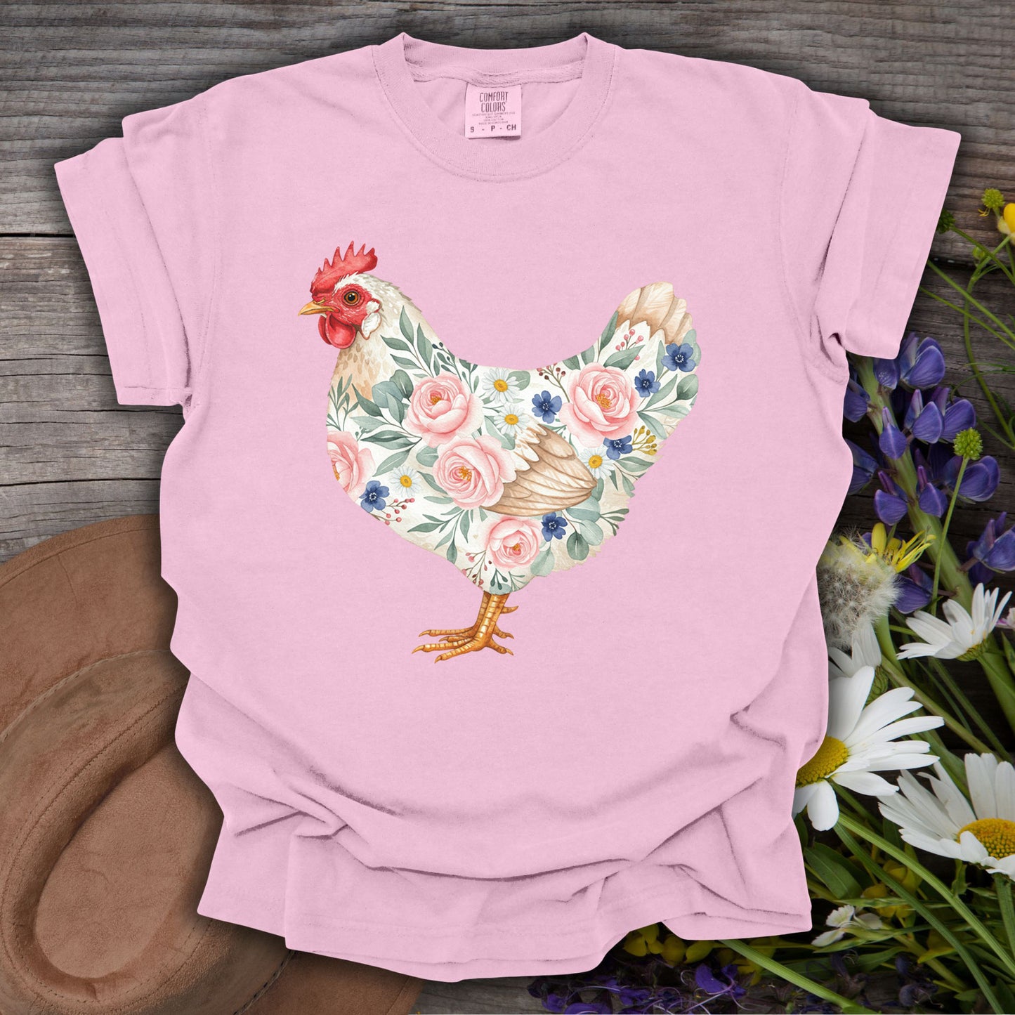 Pink garment-dyed cotton t-shirt with a botanical chicken illustration featuring roses and daisies.