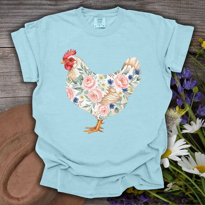 Chambray S t-shirt with a botanical chicken illustration featuring pink roses and blue flowers.