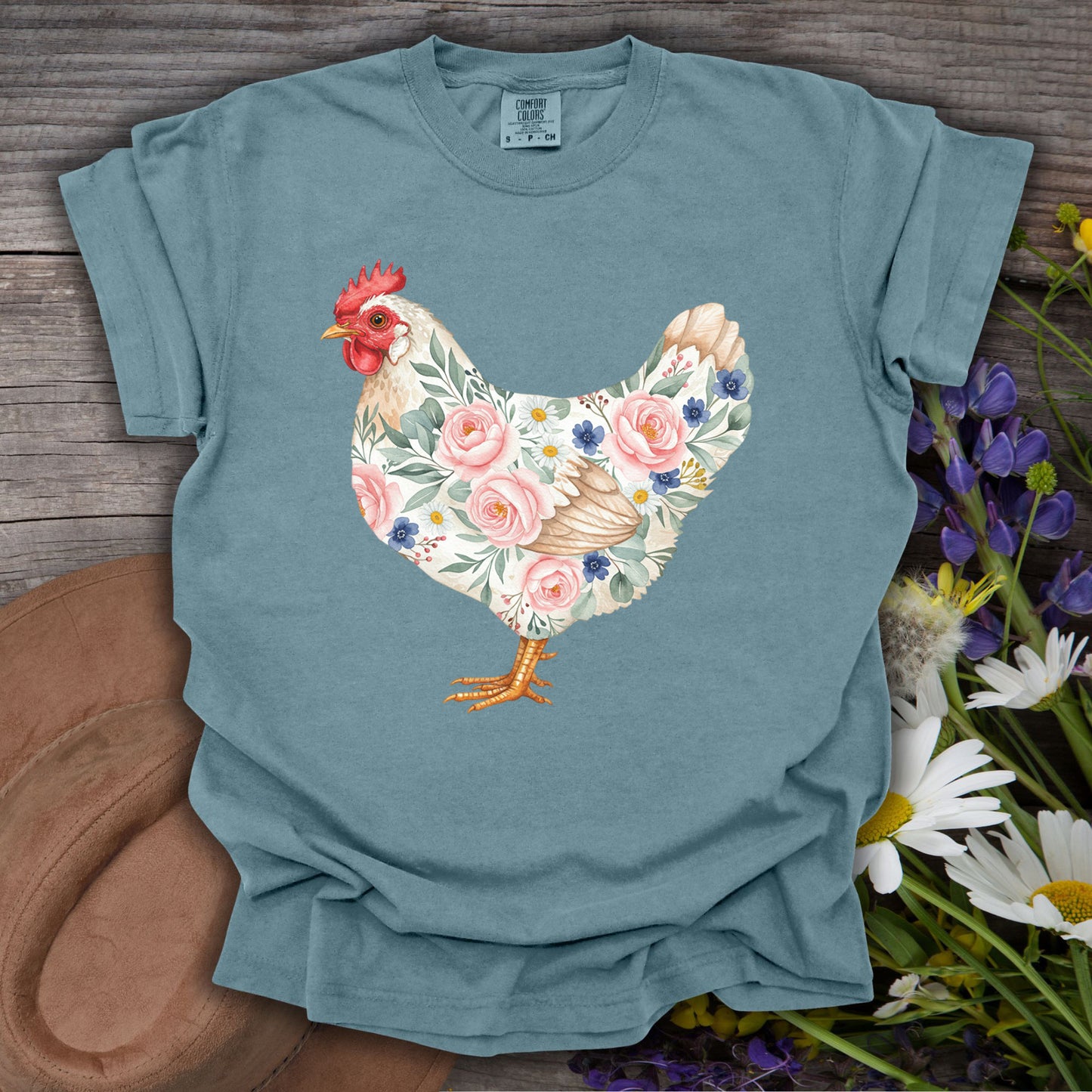 Ice Blue S t-shirt with a botanical chicken illustration featuring pink roses and blue flowers.