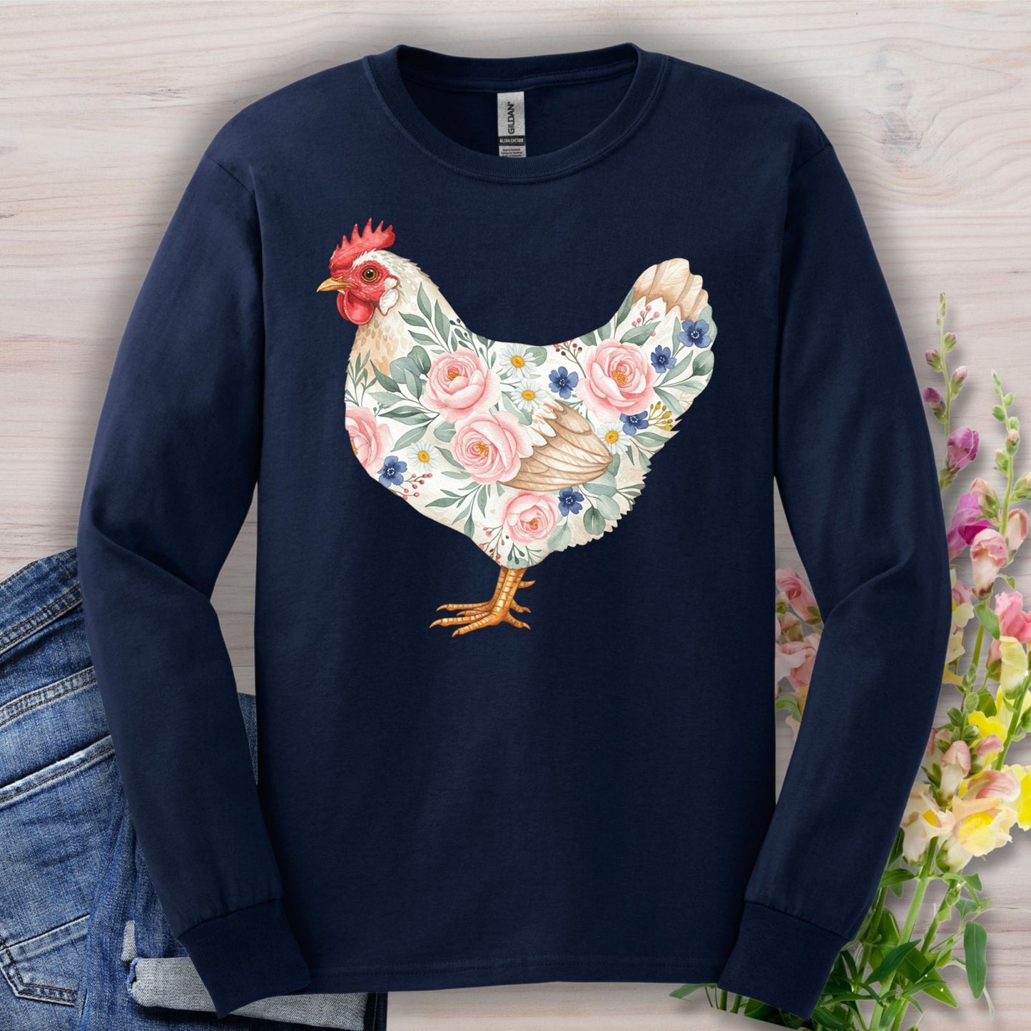 Navy long sleeve tee with a watercolor hen adorned with pink and blue botanical details.