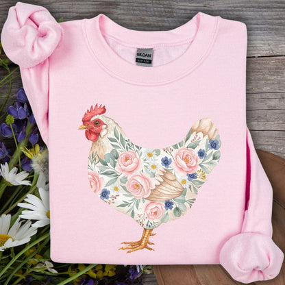 Light pink Gildan sweatshirt with a watercolor hen design adorned with roses, daisies, and forget-me-nots.