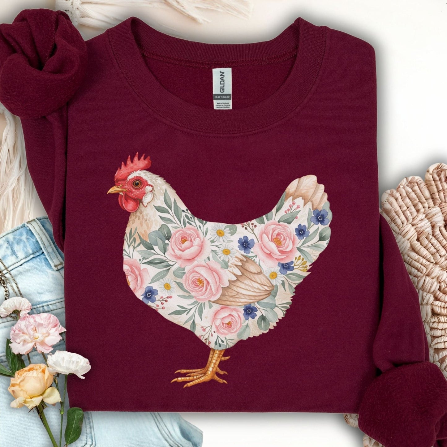 Maroon Gildan sweatshirt with a watercolor botanical hen design featuring roses and daisies.