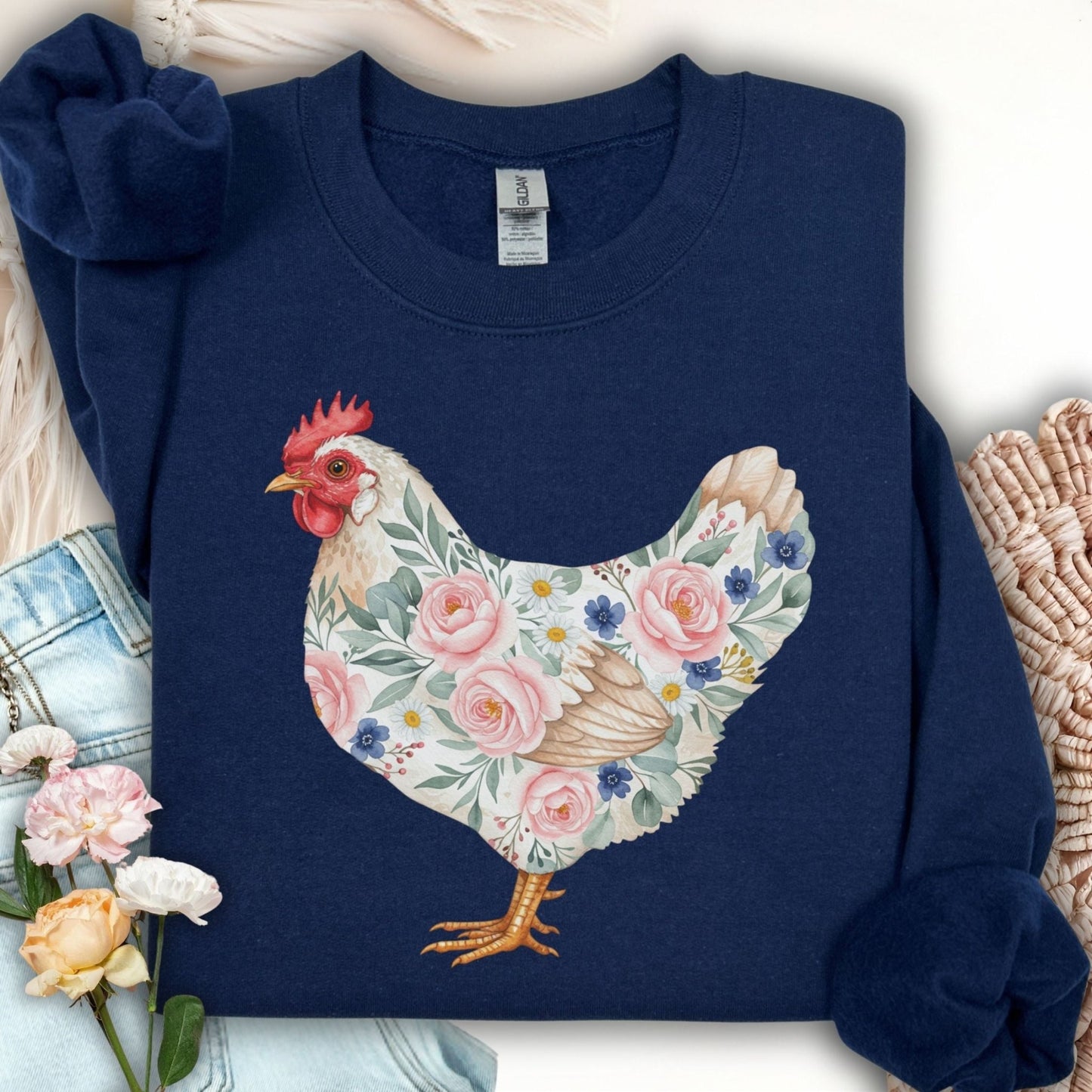 Navy S sweatshirt with a watercolor botanical hen design featuring roses, daisies, and forget-me-nots.