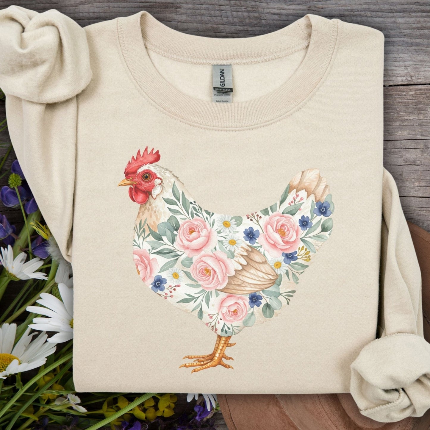 Sand sweatshirt with a watercolor floral hen design featuring pink roses and blue forget-me-nots.