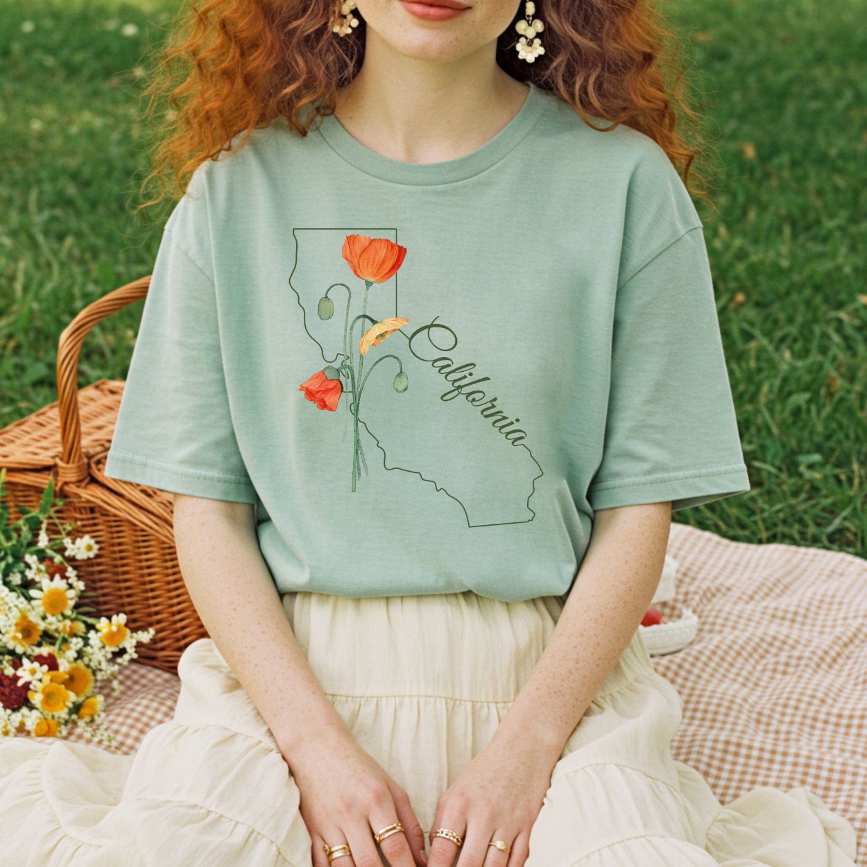 Relaxed-fit, garment-dyed sage green t-shirt with a California map outline and hand-drawn poppies.