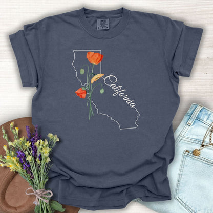 Denim blue garment-dyed cotton t-shirt with a white California outline and orange poppy design.