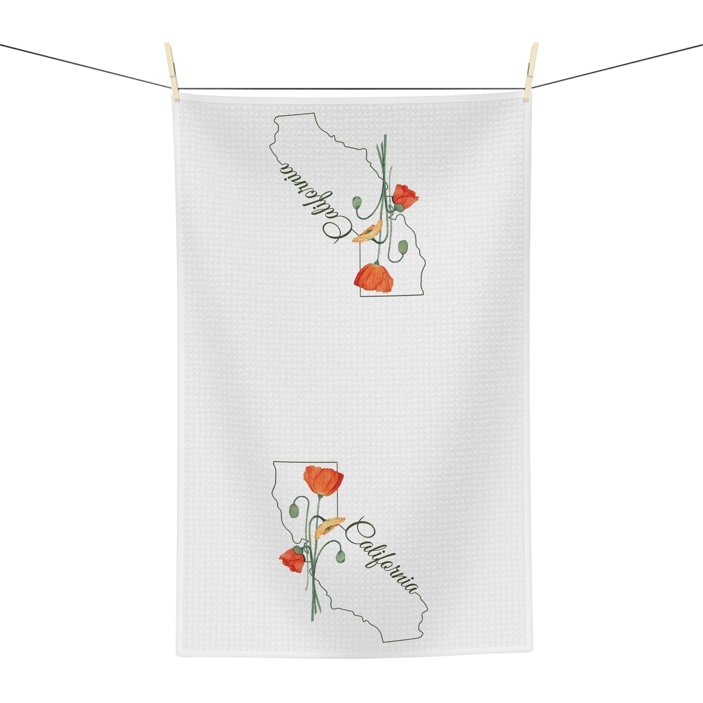 White microfiber tea towel with California outline and hand-drawn orange poppies, hanging on a clothesline.