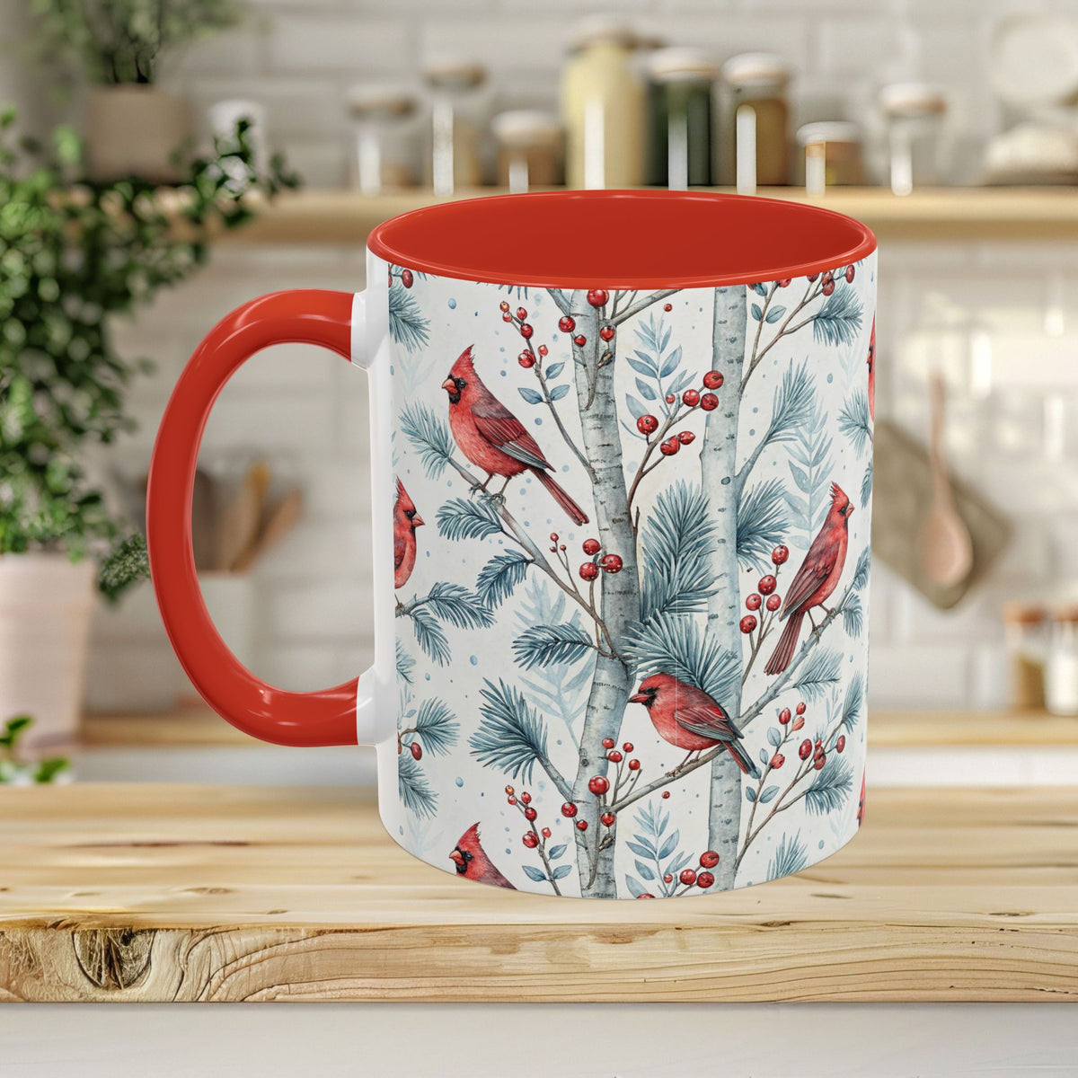 White ceramic mug with red handle and interior, featuring watercolor cardinals, birch trees, and snowy berries.