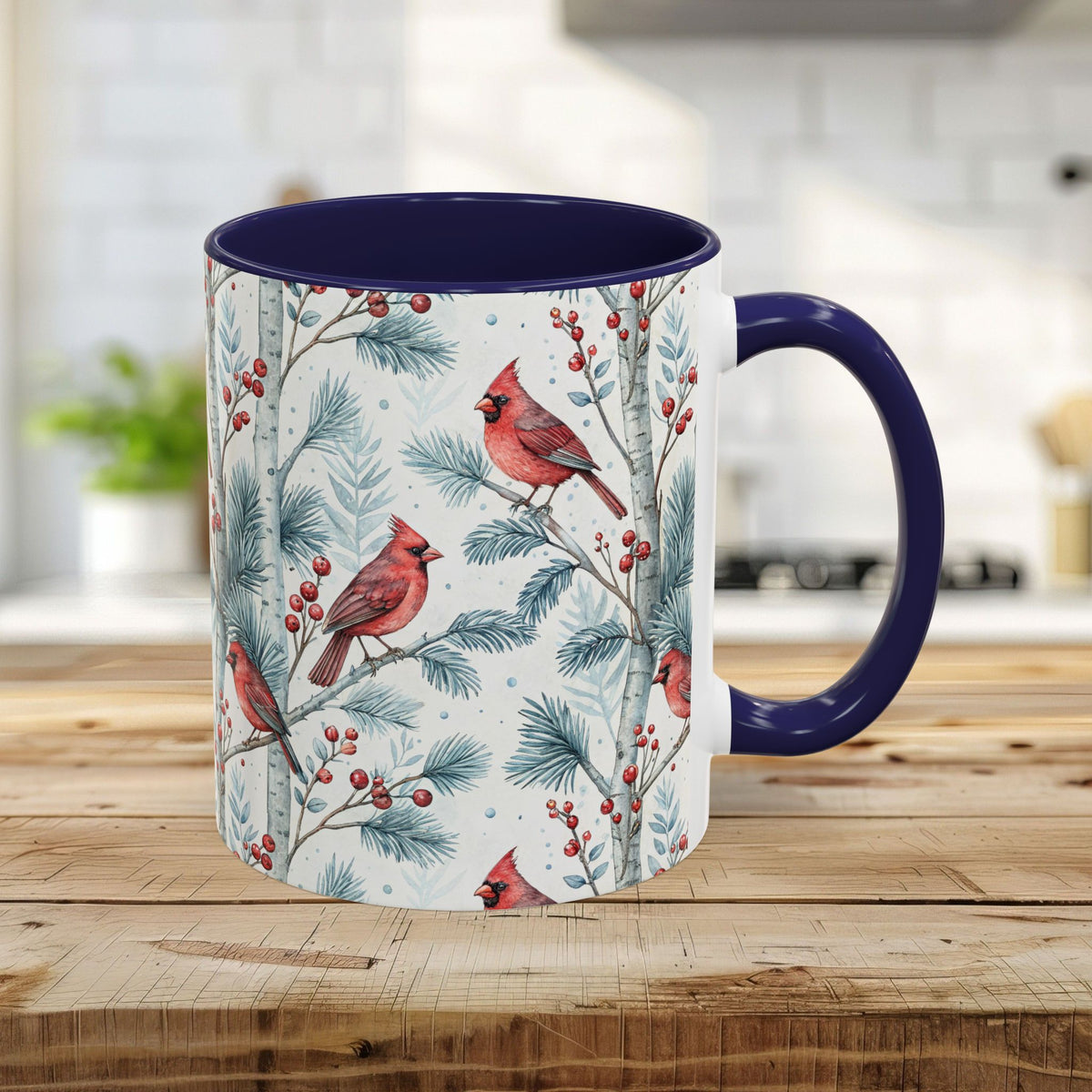 White ceramic mug with vivid watercolor cardinals, birch trees, and berries; navy blue handle and interior.
