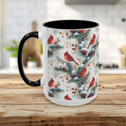 White ceramic mug with black interior and handle, featuring a watercolor cardinal on snowy evergreens design.