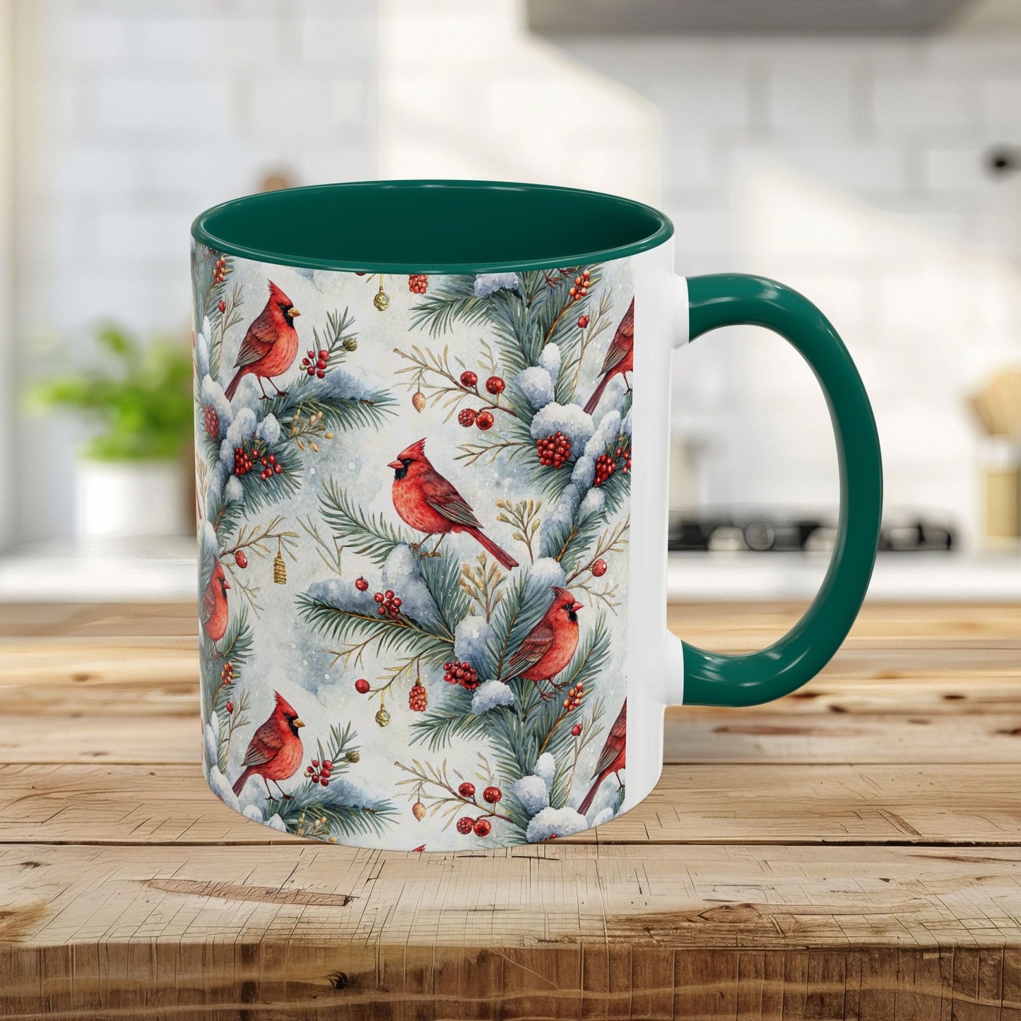 White ceramic 11oz mug with green interior/handle and watercolor cardinal on snowy evergreens design.
