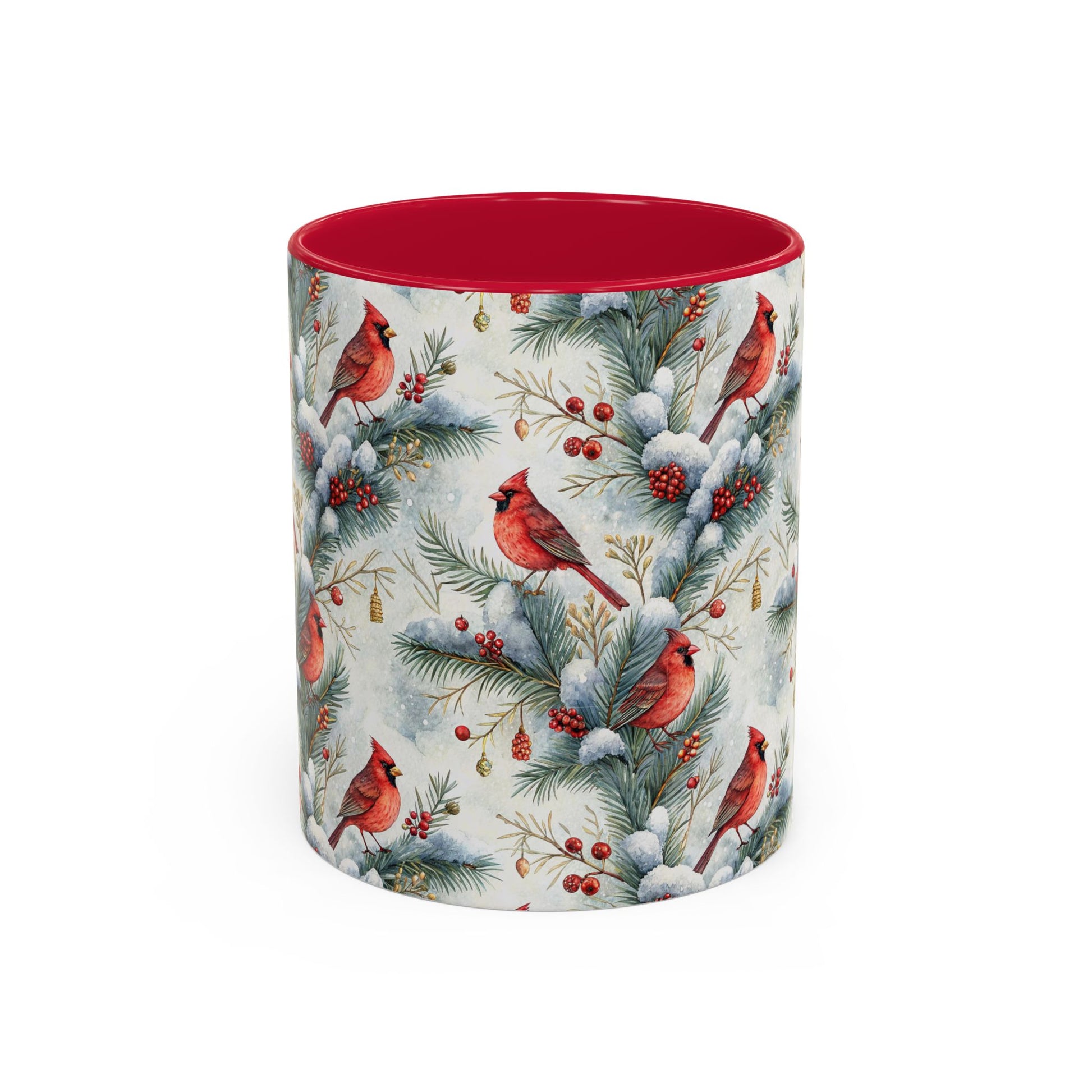 White ceramic mug with red interior and handle, featuring watercolor cardinals on snowy evergreen branches.