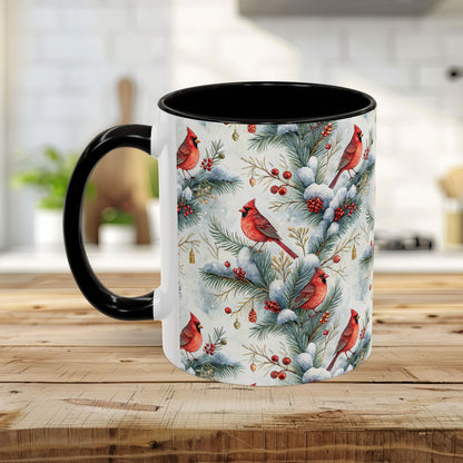 White ceramic mug with black handle and interior, featuring a watercolor cardinal and snowy evergreen design.