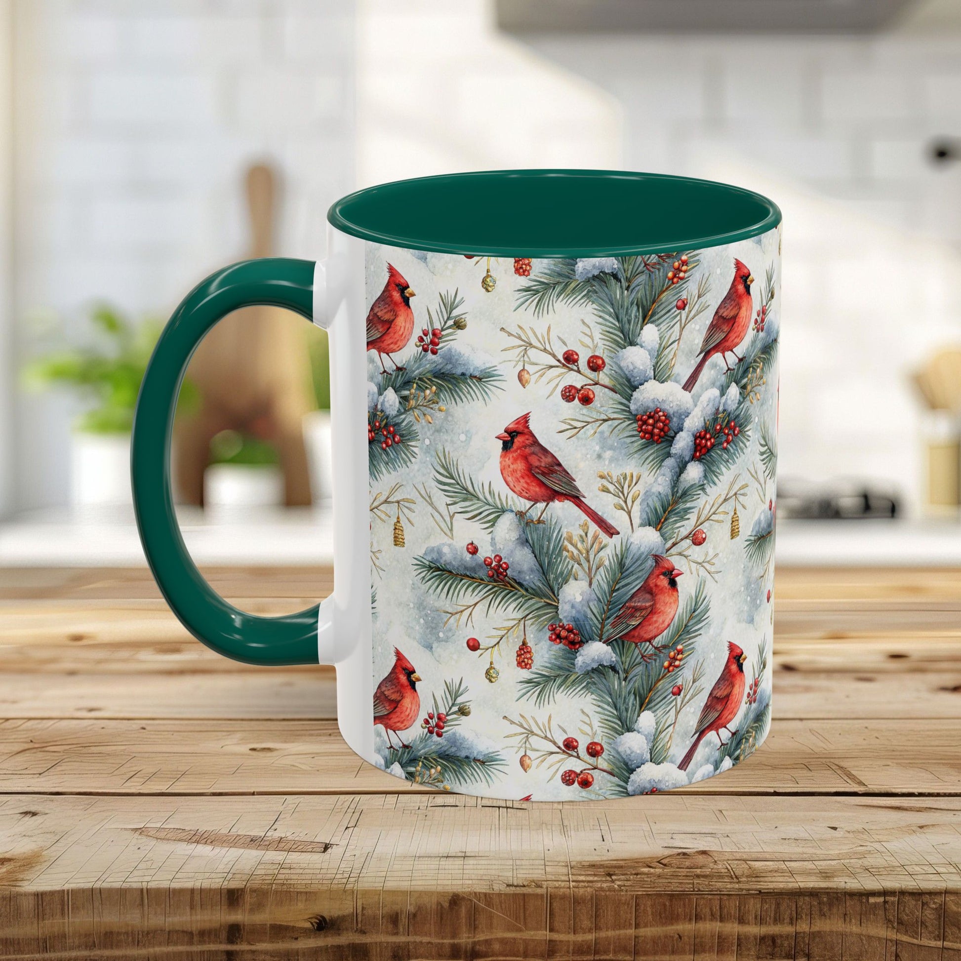 White ceramic mug with green interior and handle, featuring a watercolor print of red cardinals on snowy evergreen branches.