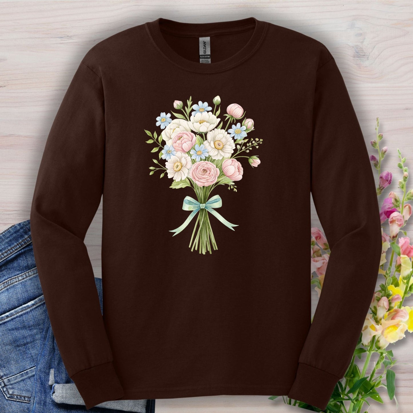 Dark Chocolate long sleeve tee with a botanical illustration of a tied bouquet of pink, white, and blue flowers.