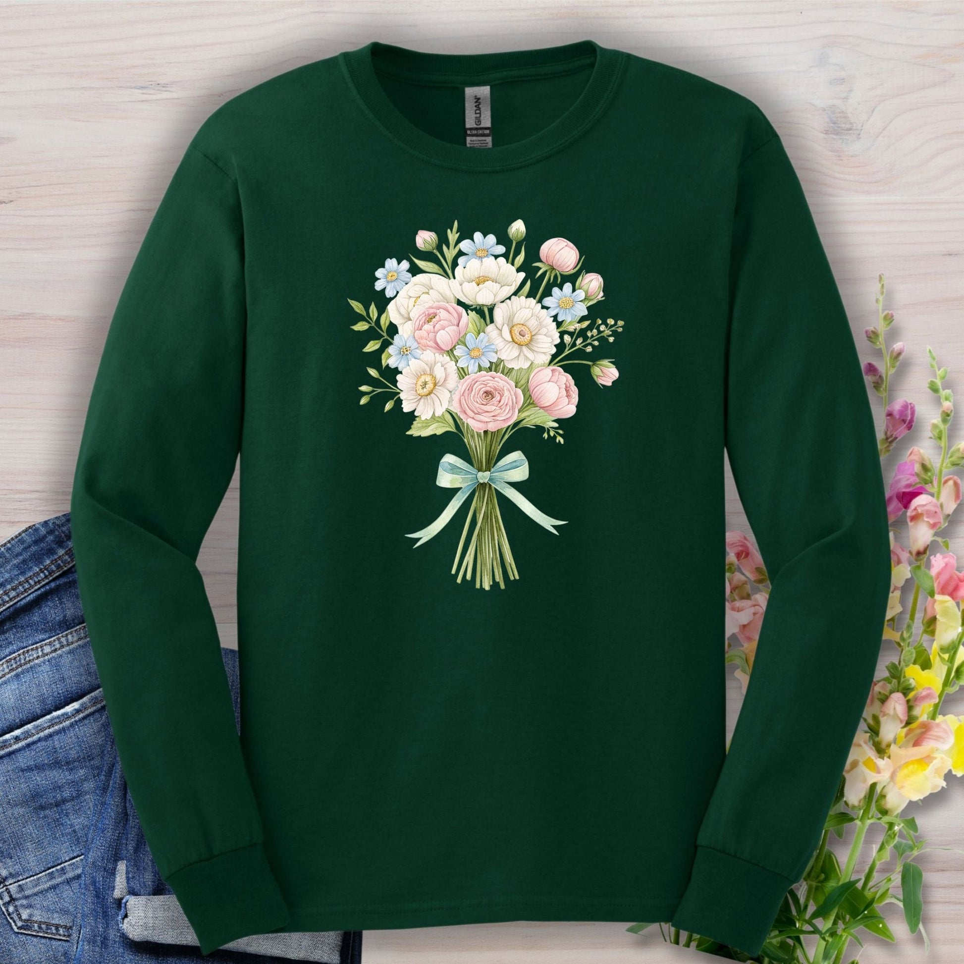 Forest Green long sleeve tee with a cheerful botanical bouquet of pink, white, and blue flowers tied with a ribbon.