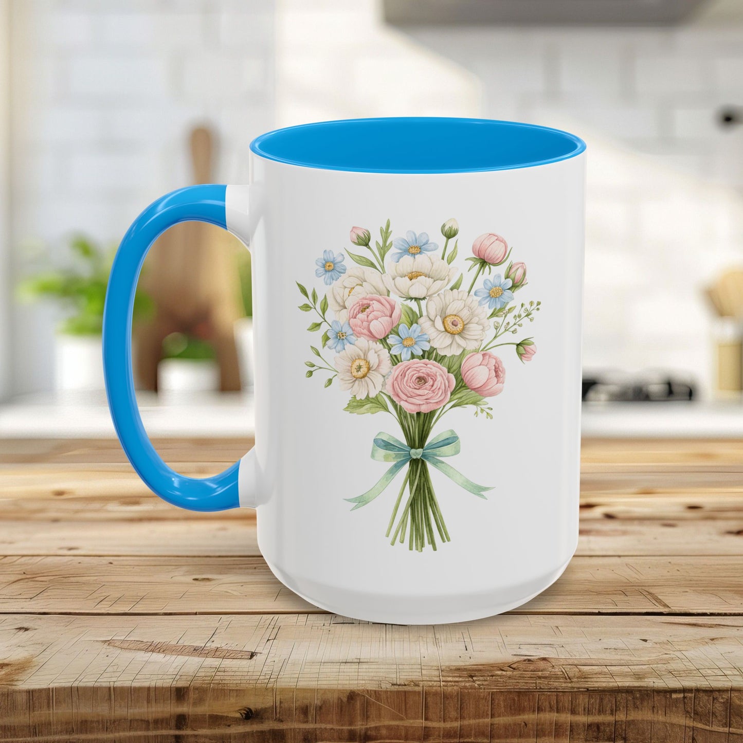 White ceramic mug with blue handle and interior, featuring a pastel floral bouquet design.