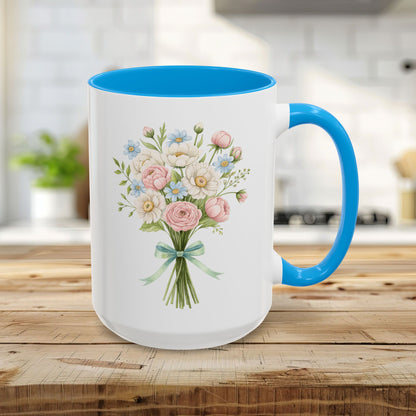 15oz ceramic mug with a light blue interior and handle, featuring a watercolor floral bouquet of pastel roses and daisies.