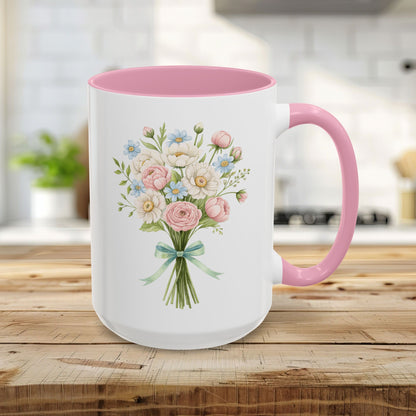 Cheerful 15oz ceramic mug with pastel floral bouquet, pink interior, and C-shaped handle on a wooden table.