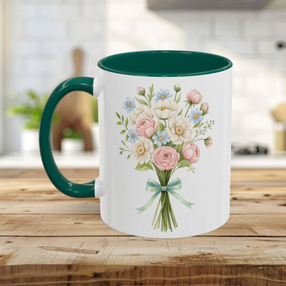 White ceramic mug with a vibrant watercolor bouquet of pastel roses and daisies, featuring a contrasting dark green interior and handle.