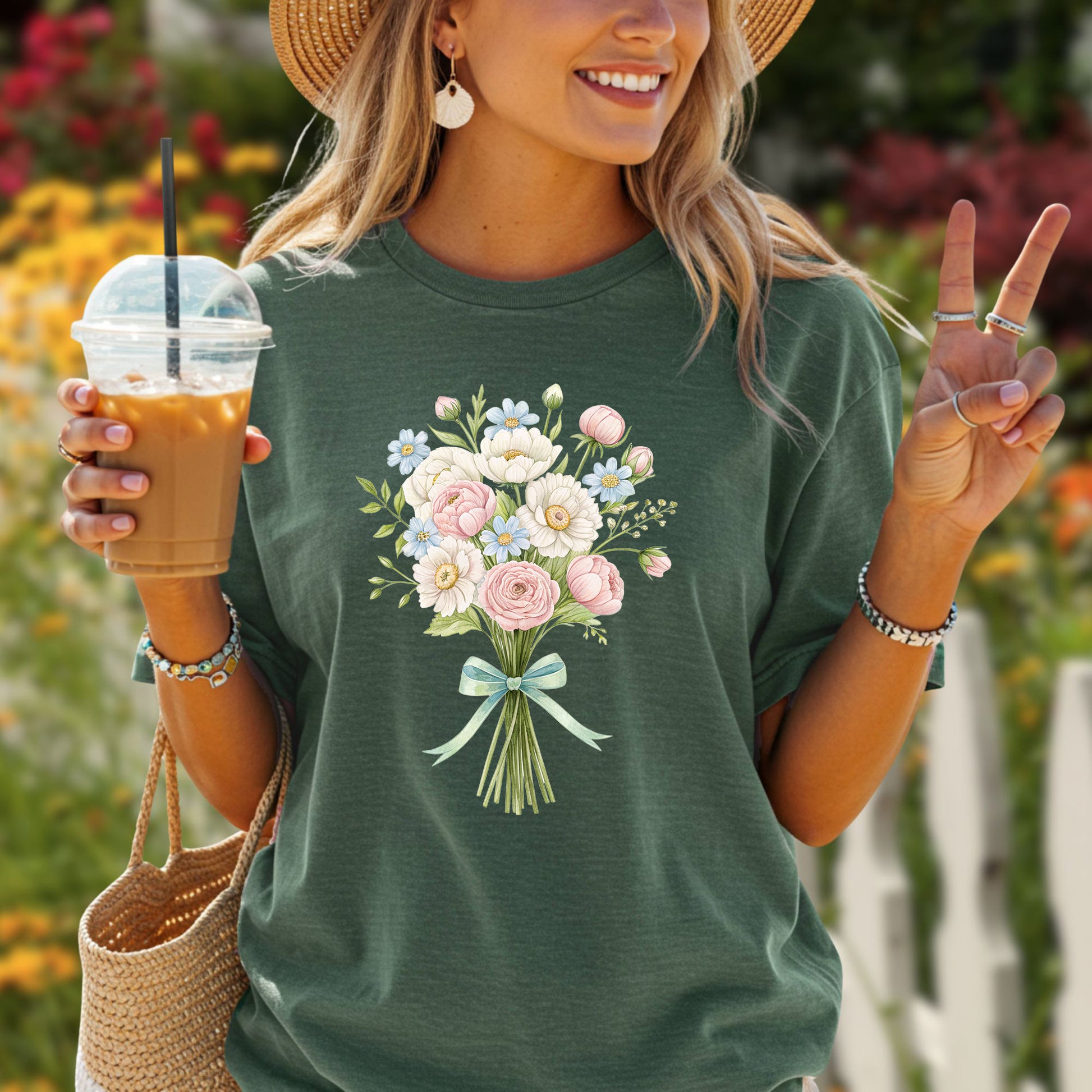 Garment-dyed forest green t-shirt with a watercolor floral bouquet and light blue ribbon.