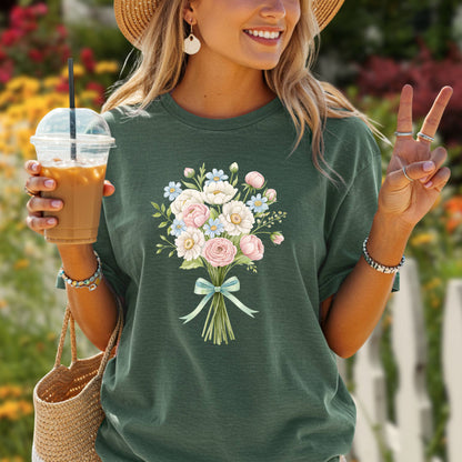 Garment-dyed forest green t-shirt with a watercolor floral bouquet and light blue ribbon.