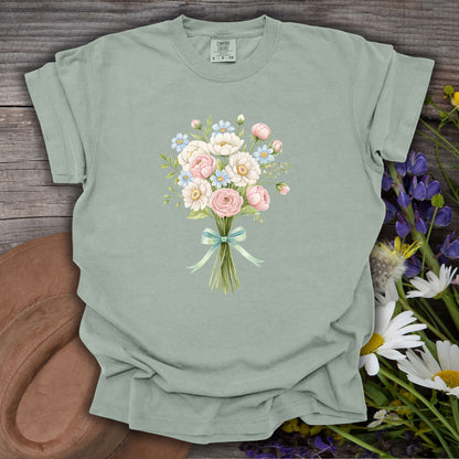 Bay S t-shirt with a watercolor bouquet of pink, white, and blue flowers tied with a green ribbon.