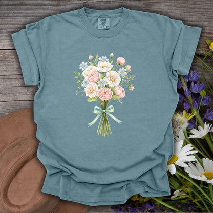 Ice Blue S t-shirt with a watercolor floral bouquet of pink and white blooms tied with a blue ribbon.