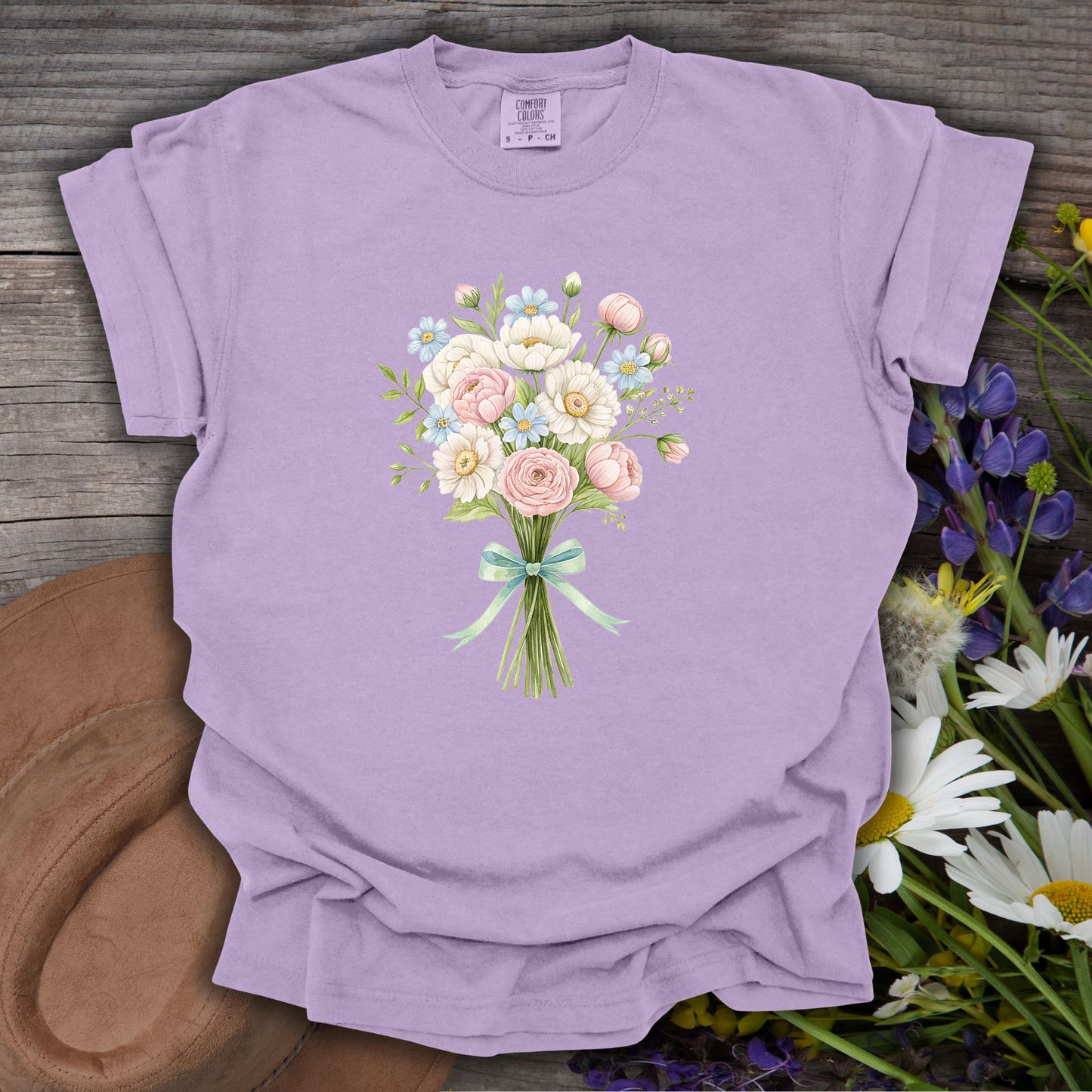 Orchid S-size garment-dyed cotton tee with a watercolor floral bouquet and mint ribbon.