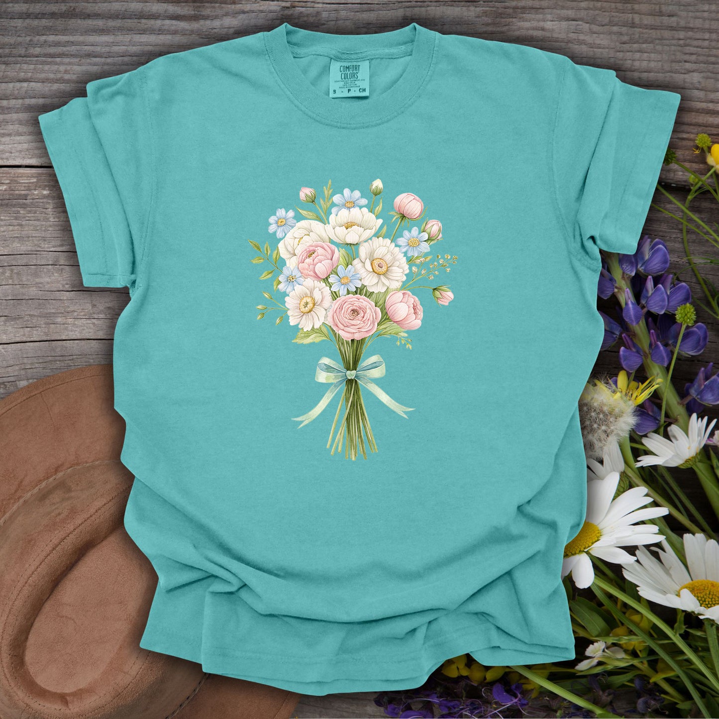 Seafoam S t-shirt with a watercolor bouquet of pink and white flowers tied with a bow.