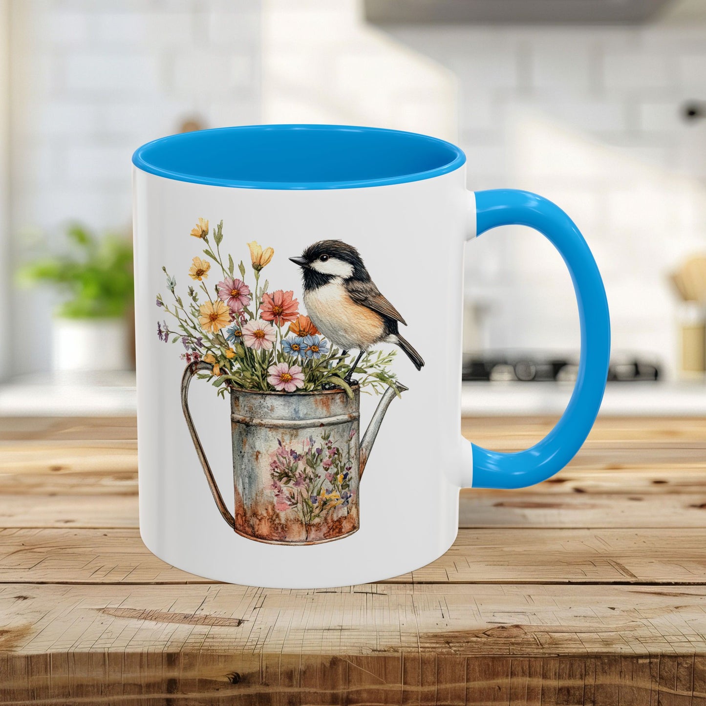 White ceramic 11oz mug with a light blue interior and handle, featuring a chickadee on a floral watering can.